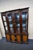 A MODERN HARDWOOD ORIENTAL STYLE BREAKFRONT DISPLAY CABINET, the four bevelled glass doors enclosing