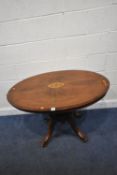 A 19TH CENTURY MAHOGANY OVAL TILT TOP TABLE, with inlaid details, raised on turned supports, four