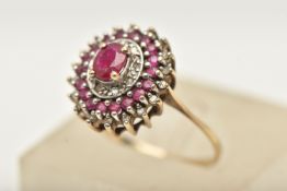 A 9CT GOLD RUBY AND DIAMOND CLUSTER RING, tiered cluster of an oval form, set with a central oval