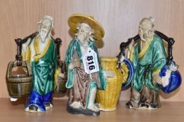 A GROUP OF THREE CHINESE EXPORT MUD MEN FIGURES comprising two different figures carrying items with