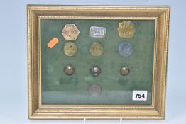 A FRAMED COLLECTION OF VINTAGE RAILWAY MEMORABILIA, comprising, brass pay check tokens to include,