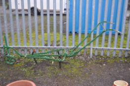 A VINTAGE WROUGHT IRON PLOUGH with some blades missing, 260cm long (not in working order)