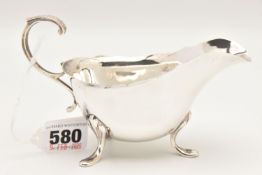 AN EARLY 20TH CENTURY SILVER SAUCE BOAT, with wavy rim and scrolling handle, hallmarked 'S W Smith &