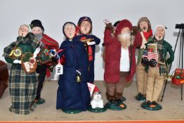 A COLLECTION OF 'THE CAROLERS' CHRISTMAS ORNAMENTS comprising nine figurines and a tripod,