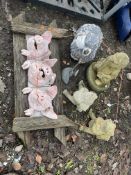 A COLLECTION GARDEN ORNAMENTS including a wooden frame with three pottery pig heads inserted, a