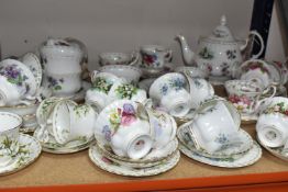 SIXTY FOUR PIECES OF ROYAL ALBERT 'FLOWERS OF THE MONTH' TEA WARE comprising a group of 'January