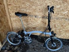 A BROMPTON FOLDING BIKE, grey, with maximum seat height 98cm from floor, 4 gears and lights
