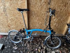 A BROMPTON FOLDING BIKE, blue, with maximum seat height 98cm from floor, 4 gears and lights