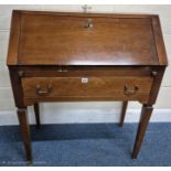 A REPRODUCTION BUREAU, the fall front door enclosing a fitted interior, over a single drawer, raised