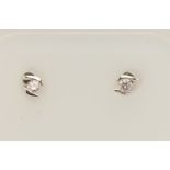 A PAIR OF 9CT WHITE GOLD DIAMOND STUD EARRINGS, each set with a small round brilliant cut diamond in