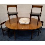 A MID-CENTURY TEAK EXTENDING DINING TABLE, with a single fold-out leaf, raised on tapered legs,