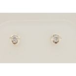 A PAIR OF 9CT WHITE GOLD DIAMOND STUD EARRINGS, each set with a small round brilliant cut diamond,