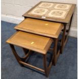 G PLAN ASTRO, A MID-CENTURY TEAK NEST OF THREE TABLES, the largest table with a tile top