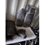 FOUR VINTAGE BRITISH MOTORCYCLE SADDLES AND PILLION SEATS, including a possible AJS seat in good