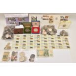 A cardboard box containing coins, banknotes and stamps. There is a bag containing .500 silver