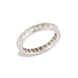 A diamond eternity ring, composed of channel-set princess-cut diamonds, ring width 3.3mm, ring si...