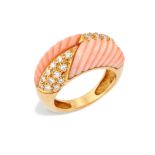 A French coral and diamond ring, the bombé head with quartered carved coral and pavé brilliant-cu...