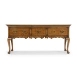 An English oak dresser base, of George III style, last quarter 20th century, with three drawers a...