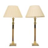 A pair of brass columnar table lamps, 20th century, with patinated columns, polished capitals and...