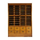 An English oak haberdashery cabinet, by E.Pollard & Co, first quarter 20th century, with four gla...