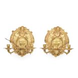 A pair of gilt-bronze twin-light girandoles, second half 20th century, with twin scrolling arms s...