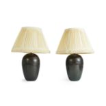 A pair of large Art Deco style resin table lamps, late 20th century, with pleated fabric and frin...