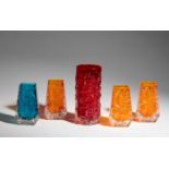 Four moulded glass 'Coffin' vases and a 'Bark' vase, from the 'Textured' range by Geoffrey Baxter...