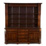 A George III mahogany crossbanded oak dresser, third quarter 18th century, the plate rack with in...