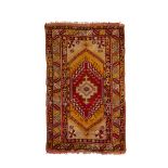 A Turkish rug, first quarter 20th century, the central field with geometric medallion surrounded ...