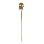 A French early 20th century lava stone stick pin, the carved lava stone finial designed as a skul...