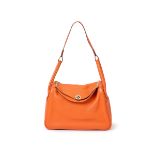 Hermès. Lindy 30, 2015, of orange in togo leather, palladium hardware, comes with the bag and th...