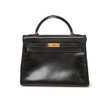 Hermès. A rare and vintage Kelly 32, 1992, of noir box leather retourné with gold hardware, come...
