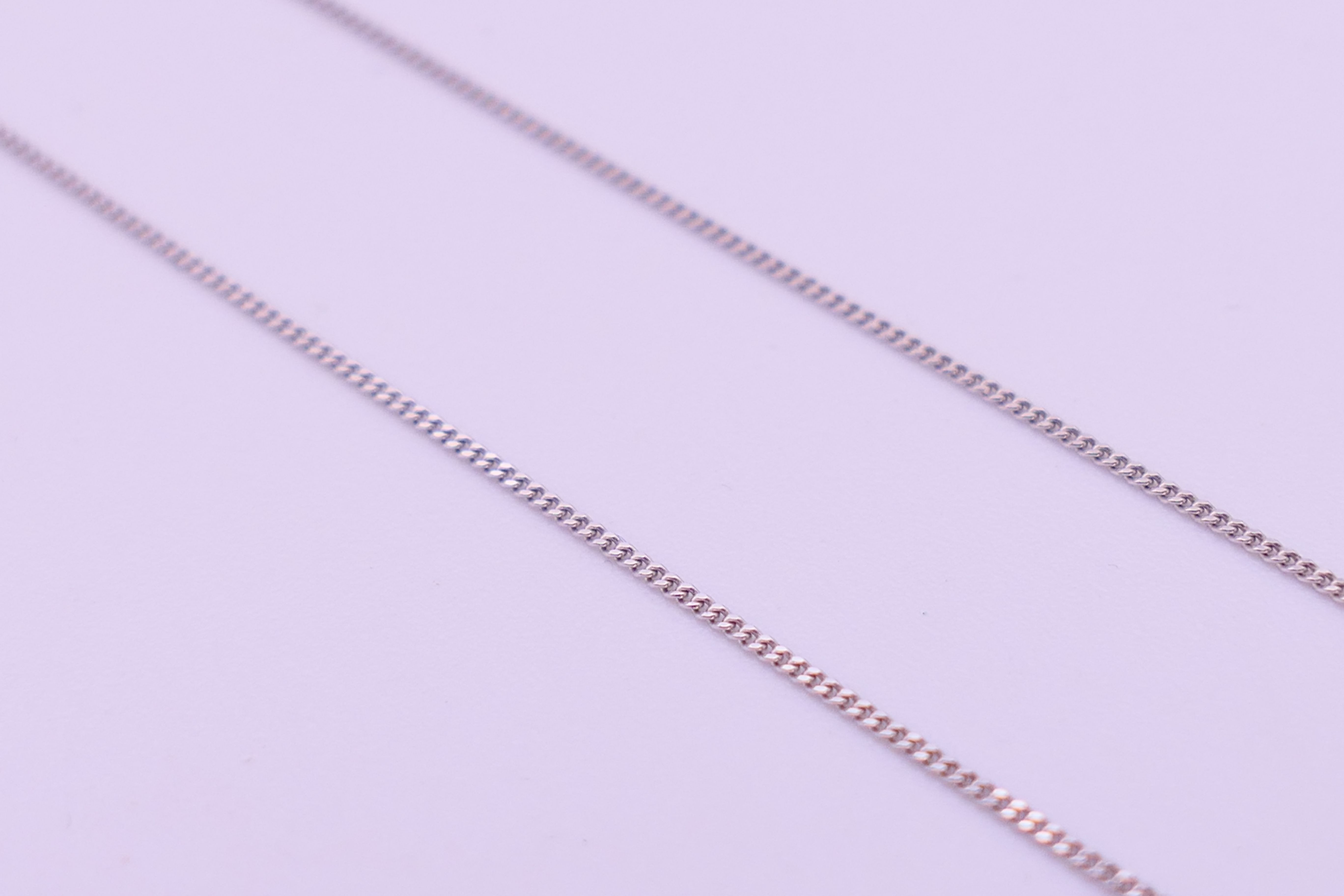 A 9 ct white gold and diamond pendant necklace. Pendant drop 3 cm high, chain 45 cm long. 3. - Image 7 of 8