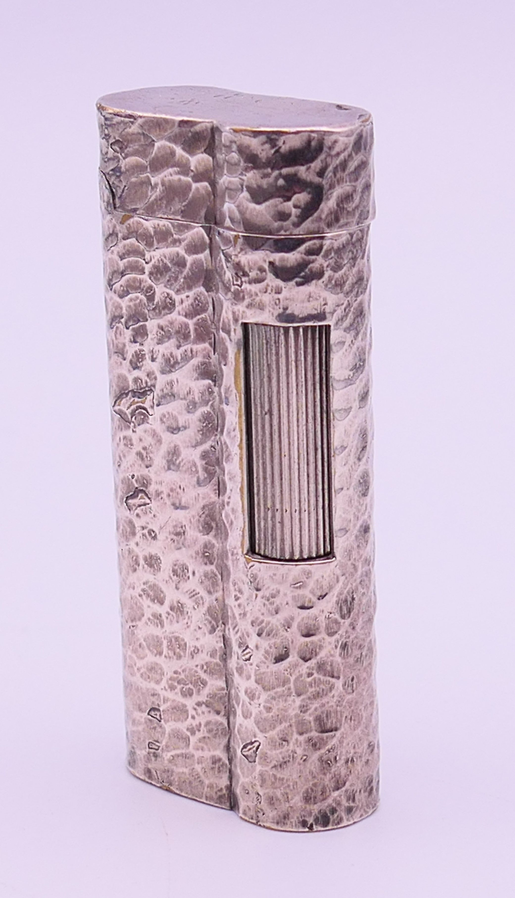 A silver plated Dunhill lighter. 6.5 cm high.