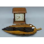 A wooden leaf-form platter and a wooden mantle clock. The former 58 cm long.