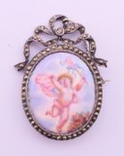 A 19th century unmarked silver and enamel brooch decorated with a putto. 5 cm high.