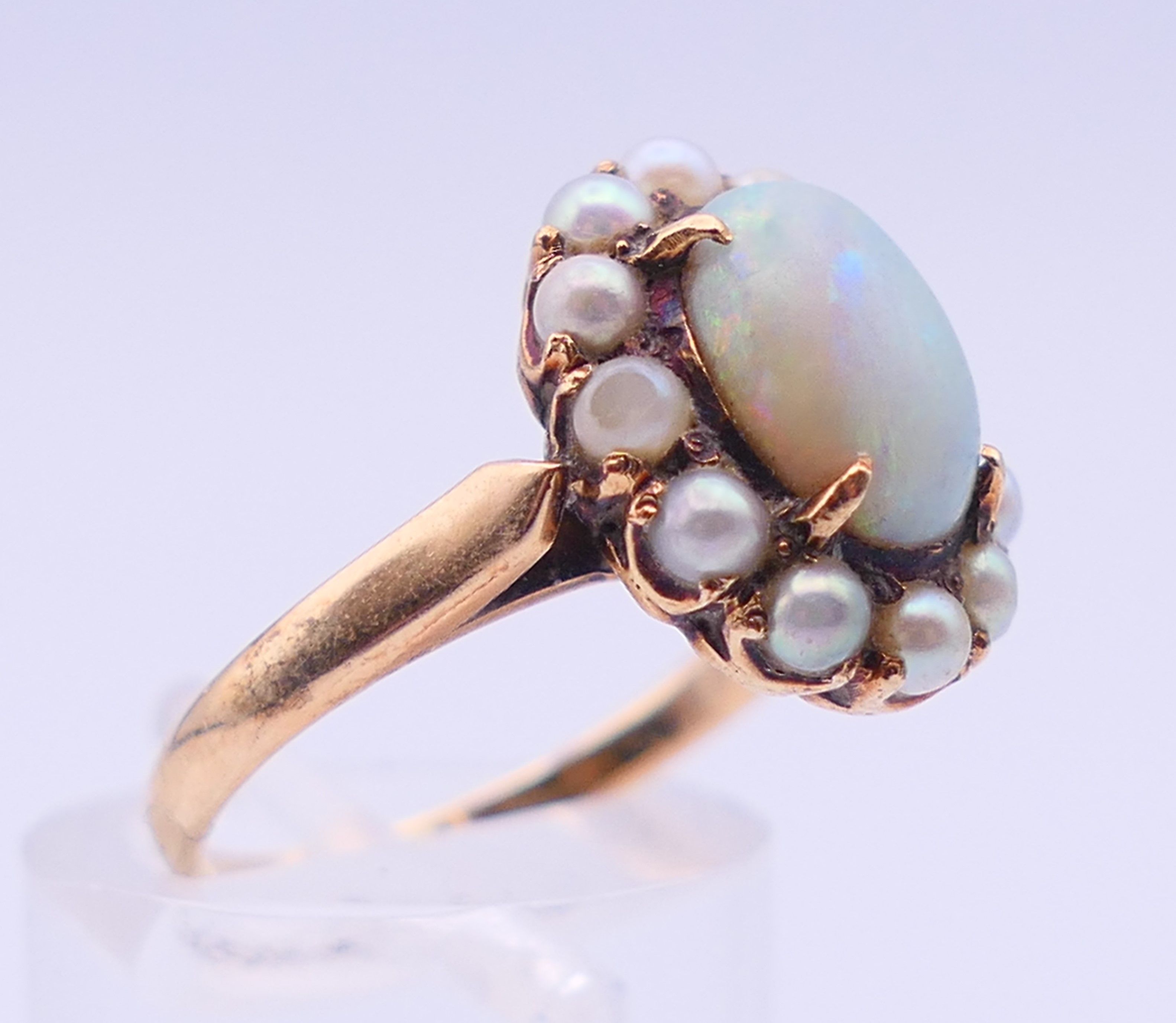 An unmarked gold, opal and seed pearl ring. Ring size M/N. 4 grammes total weight. - Image 3 of 5