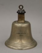 A bronze ship's bell inscribed LANCRASU 1947. 17 cm high.