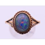 A 9 ct gold and black opal ring. Ring size T. 3.4 grammes total weight.