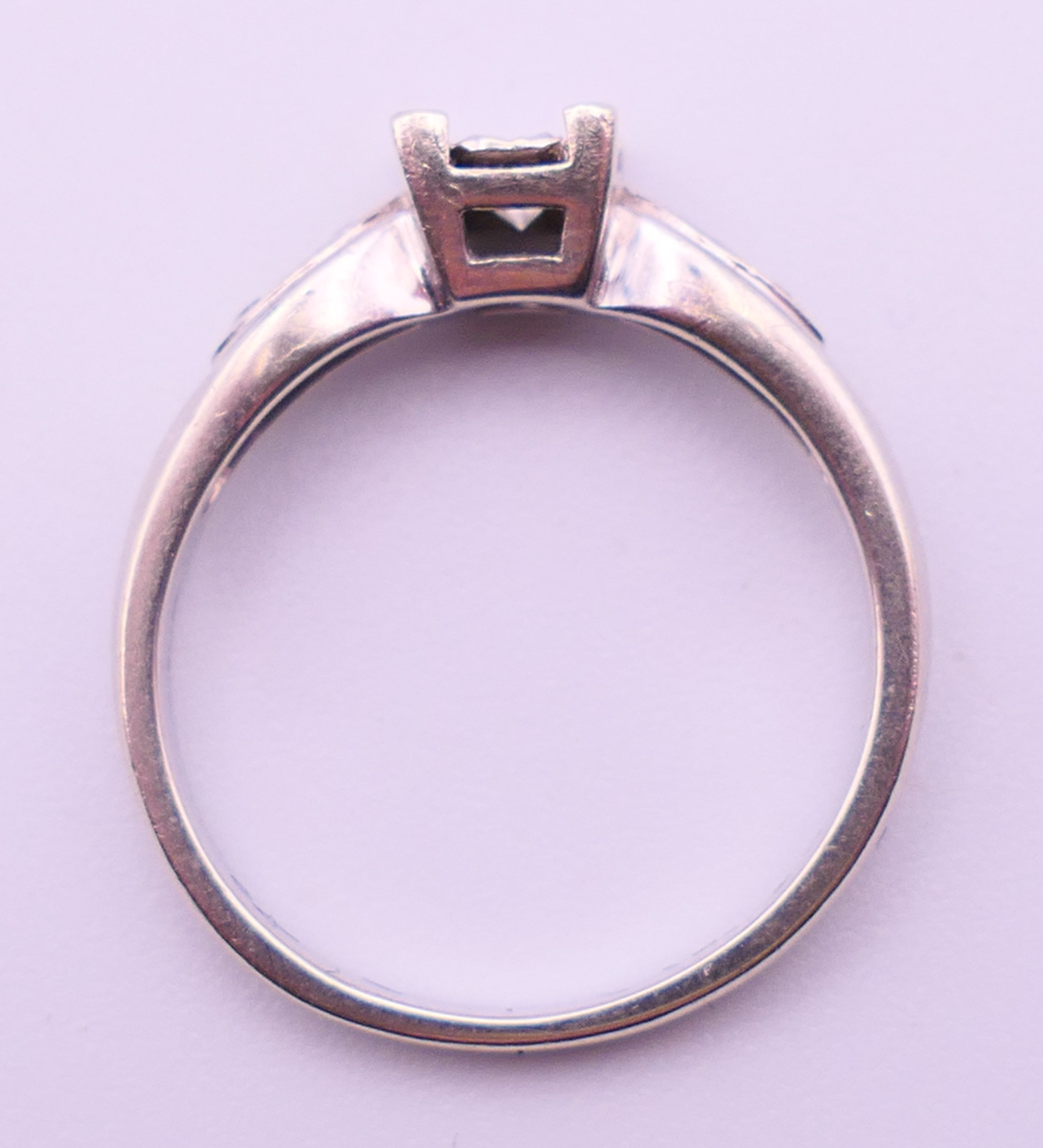 A 9 ct white gold and 0.20 carat diamond ring. Ring size N/O. 2.9 grammes total weight. - Image 5 of 5