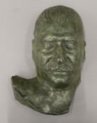 A patinated bronze model of Stalin's death mask initialled JEP and dated 1953. 32 cm high.