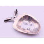 A Liberty & Co Art Nouveau silver caddy spoon. 7 cm long.
