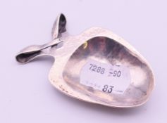 A Liberty & Co Art Nouveau silver caddy spoon. 7 cm long.