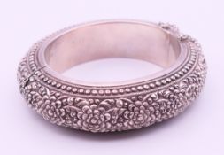 An unmarked silver (white metal) embossed bracelet.