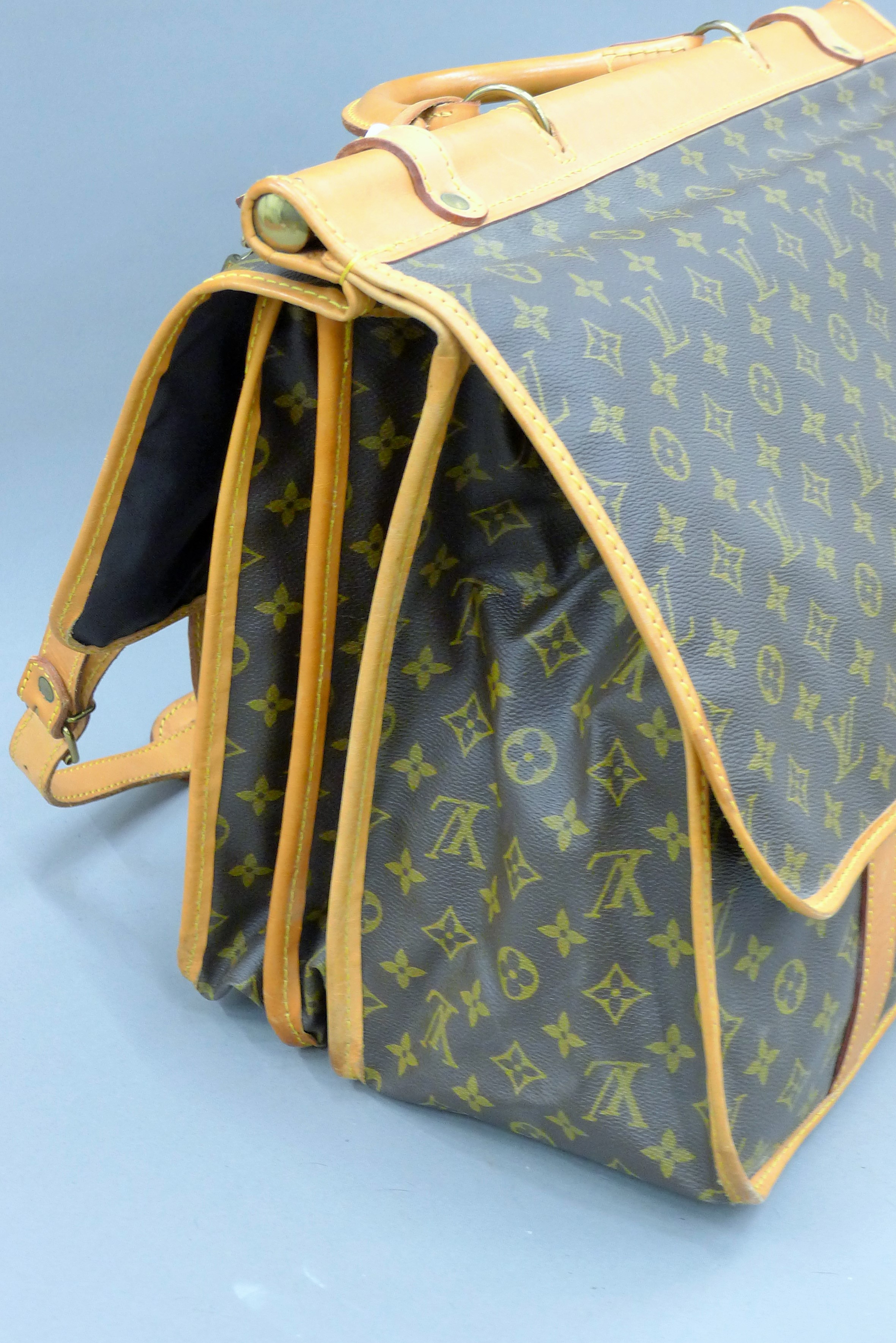 A vintage 1980's Louis Vuitton three-pocket travel bag with leather trim and shoulder strap. - Image 9 of 16