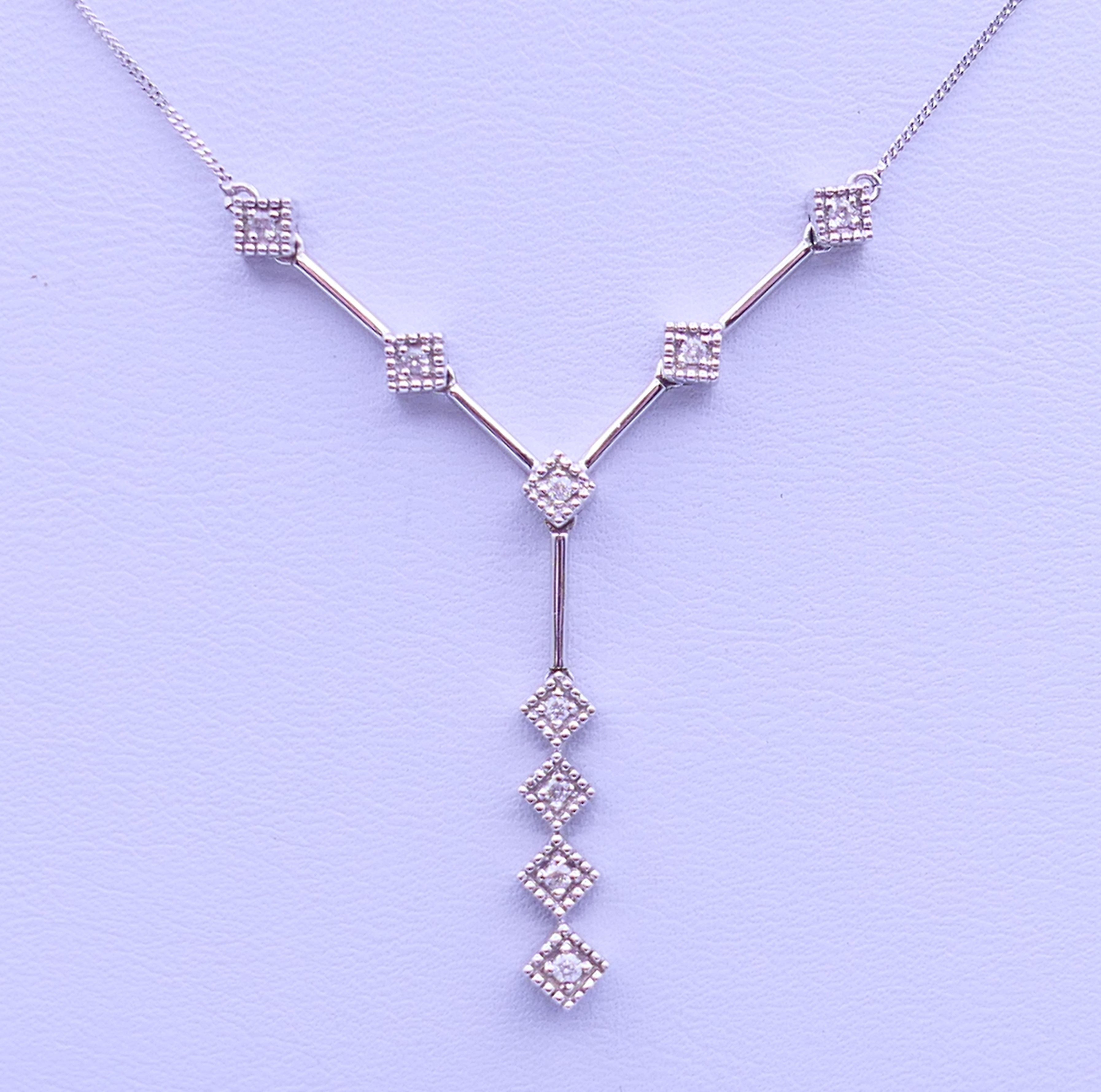 A 9 ct white gold and diamond pendant necklace. Pendant drop 3 cm high, chain 45 cm long. 3.