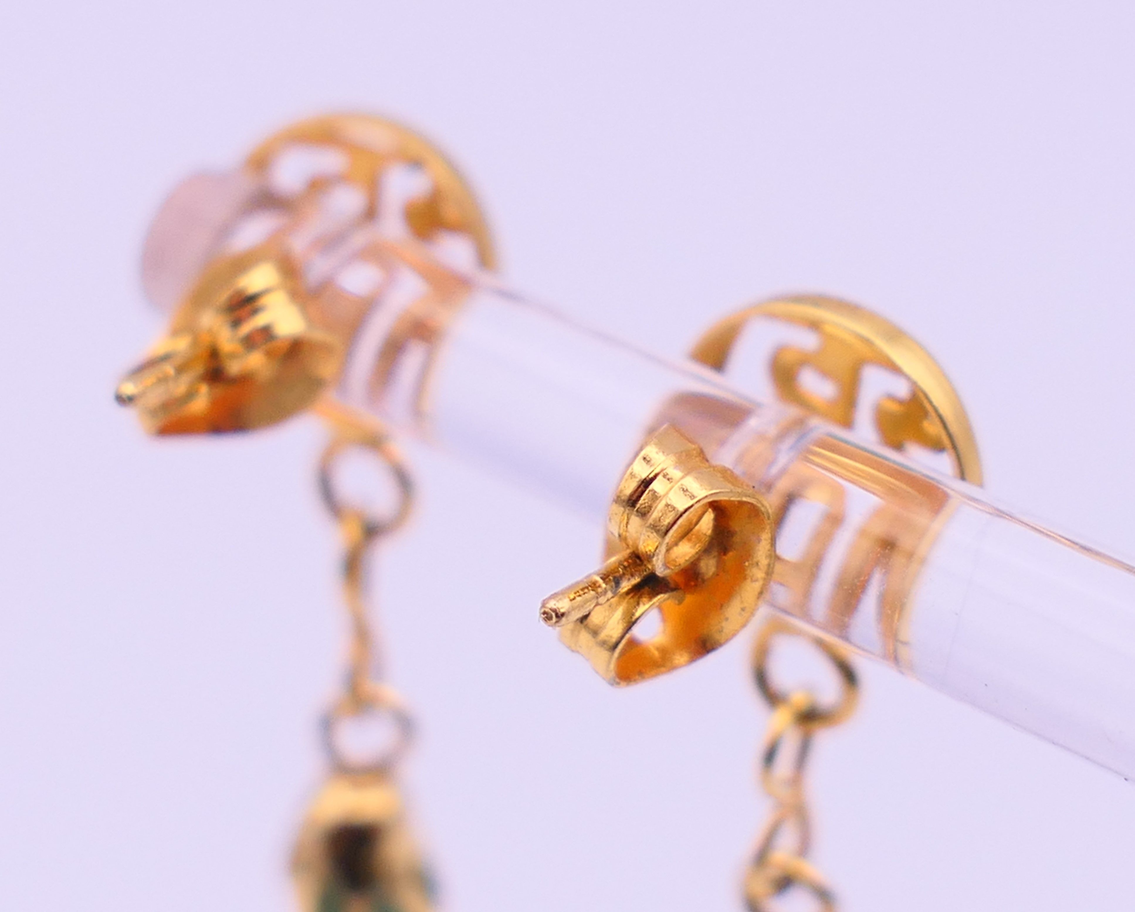 A pair of Chinese unmarked yellow metal mounted jade earrings. 4 cm high. - Image 3 of 5