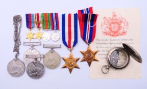 A collection of WWII medals and a Negretti and Zambra compass.