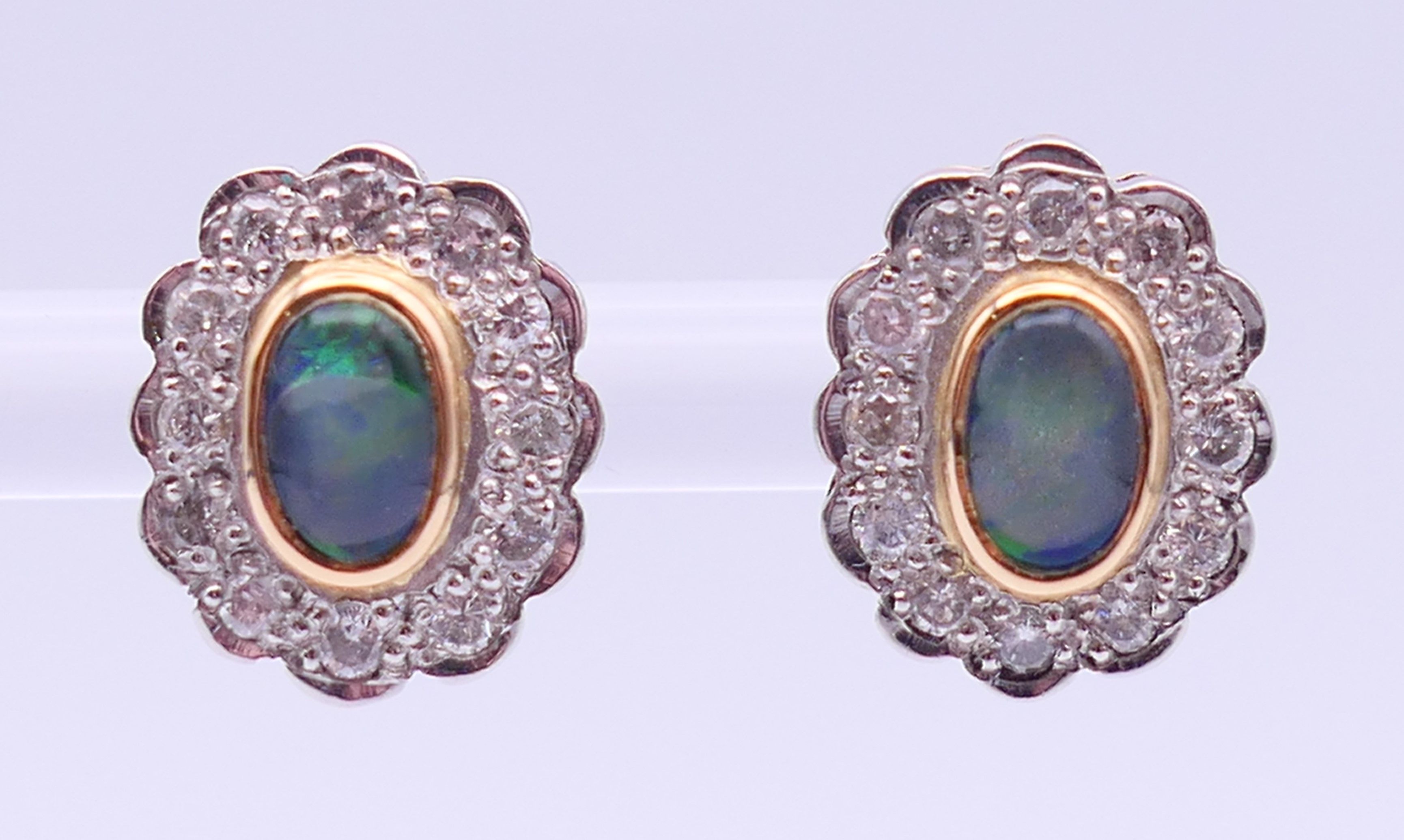 A pair of unmarked gold, diamond and opal earrings. 1.25 cm high.