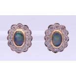 A pair of unmarked gold, diamond and opal earrings. 1.25 cm high.